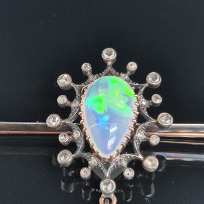 Lot 2 - An antique opal and diamond ornate bar brooch....
