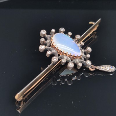 Lot 2 - An antique opal and diamond ornate bar brooch....