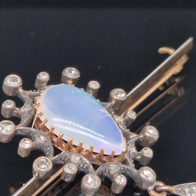 Lot 2 - An antique opal and diamond ornate bar brooch....