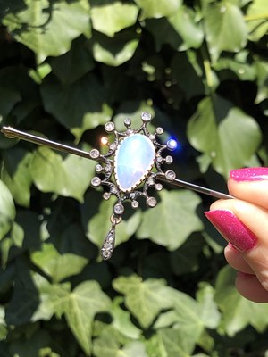 Lot 2 - An antique opal and diamond ornate bar brooch....