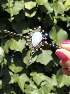Lot 2 - An antique opal and diamond ornate bar brooch....