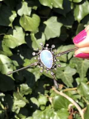 Lot 2 - An antique opal and diamond ornate bar brooch....