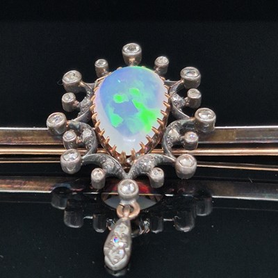 Lot 2 - An antique opal and diamond ornate bar brooch....