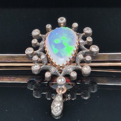 Lot 2 - An antique opal and diamond ornate bar brooch....