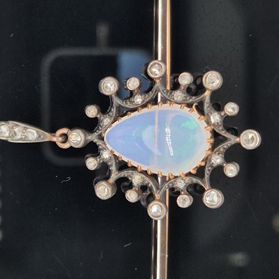 Lot 2 - An antique opal and diamond ornate bar brooch....