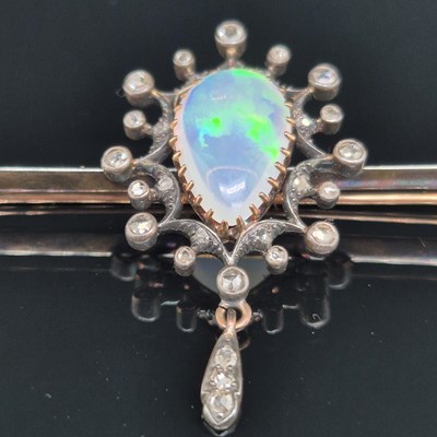 Lot 2 - An antique opal and diamond ornate bar brooch....