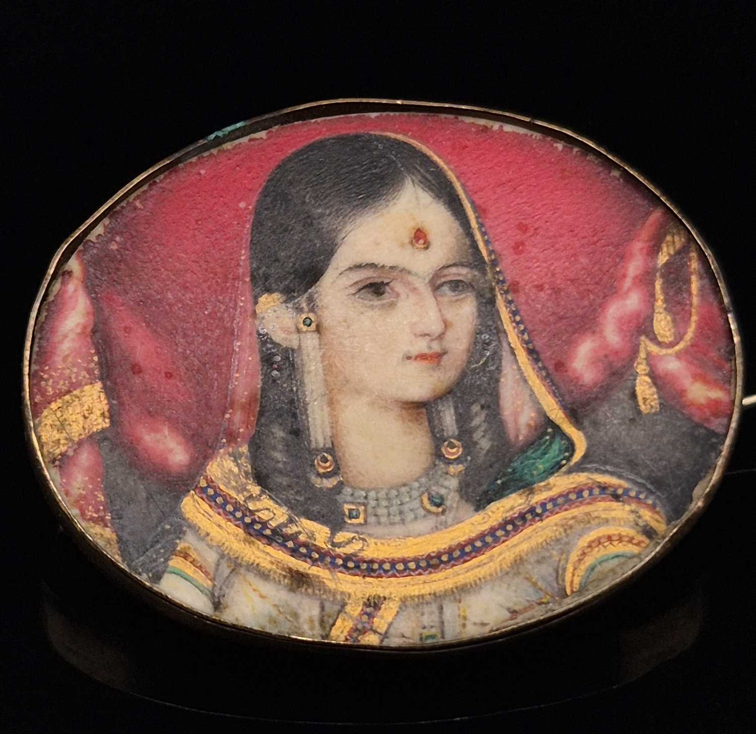Lot 3 - An antique Indian portrait miniature brooch on...