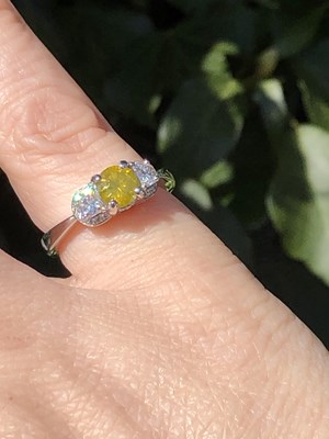 Lot 19 - A certificated fancy yellow diamond and...