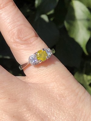 Lot 19 - A certificated fancy yellow diamond and...