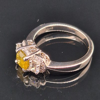 Lot 19 - A certificated fancy yellow diamond and...