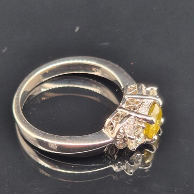 Lot 19 - A certificated fancy yellow diamond and...
