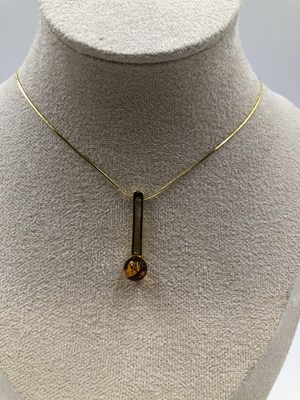 Lot 23 - A contemporary amber set pendant in a...