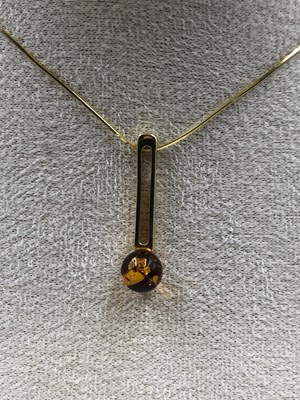 Lot 23 - A contemporary amber set pendant in a...