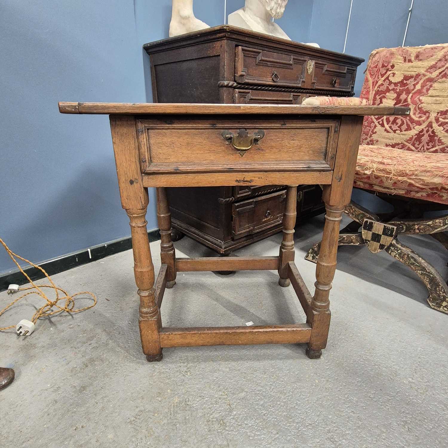 Lot 475 - An 18th century oak cleated plank top table,...