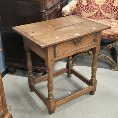 Lot 475 - An 18th century oak cleated plank top table,...