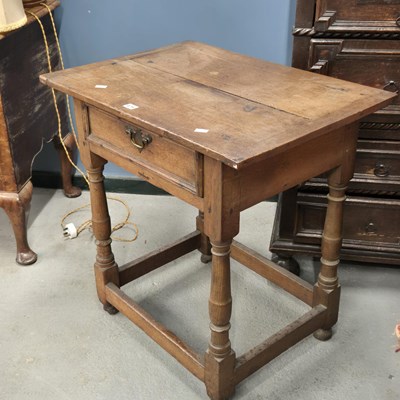 Lot 475 - An 18th century oak cleated plank top table,...