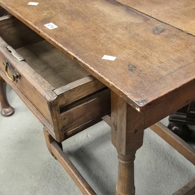 Lot 475 - An 18th century oak cleated plank top table,...