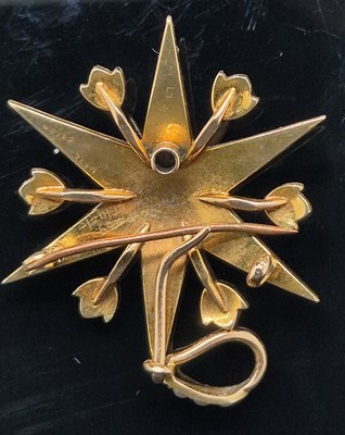 Lot 25 - An antique pearl set starburst pendant brooch...