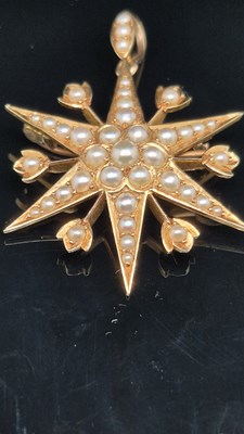 Lot 25 - An antique pearl set starburst pendant brooch...