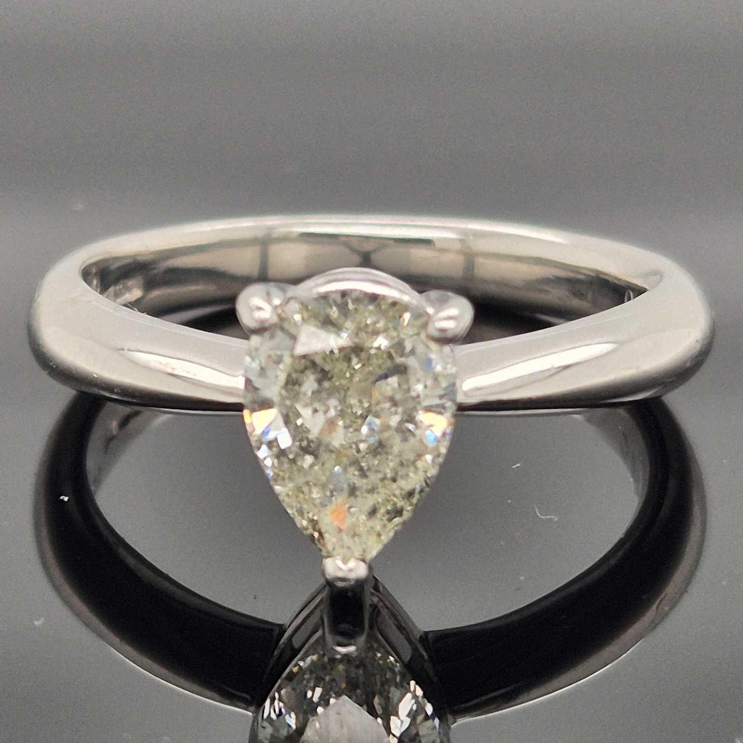 Lot 35 - A platinum hallmarked and pear-cut diamond...