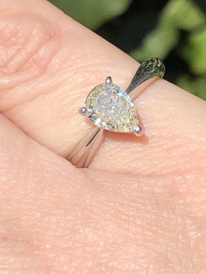 Lot 35 - A platinum hallmarked and pear-cut diamond...