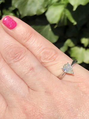 Lot 35 - A platinum hallmarked and pear-cut diamond...