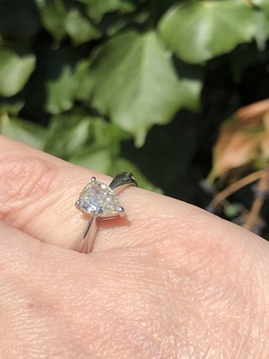 Lot 35 - A platinum hallmarked and pear-cut diamond...