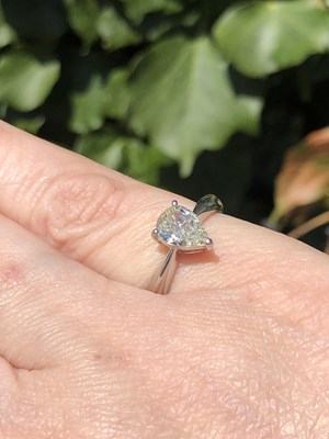 Lot 35 - A platinum hallmarked and pear-cut diamond...