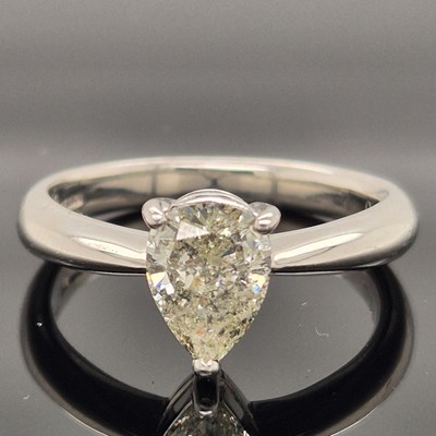 Lot 35 - A platinum hallmarked and pear-cut diamond...