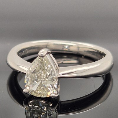 Lot 35 - A platinum hallmarked and pear-cut diamond...