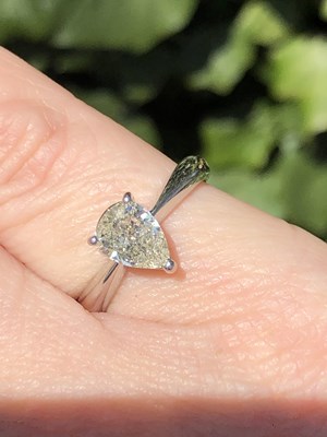 Lot 35 - A platinum hallmarked and pear-cut diamond...