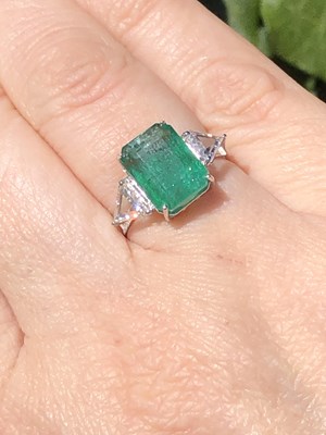 Lot 60 - An 18ct hallmarked white gold, emerald and...