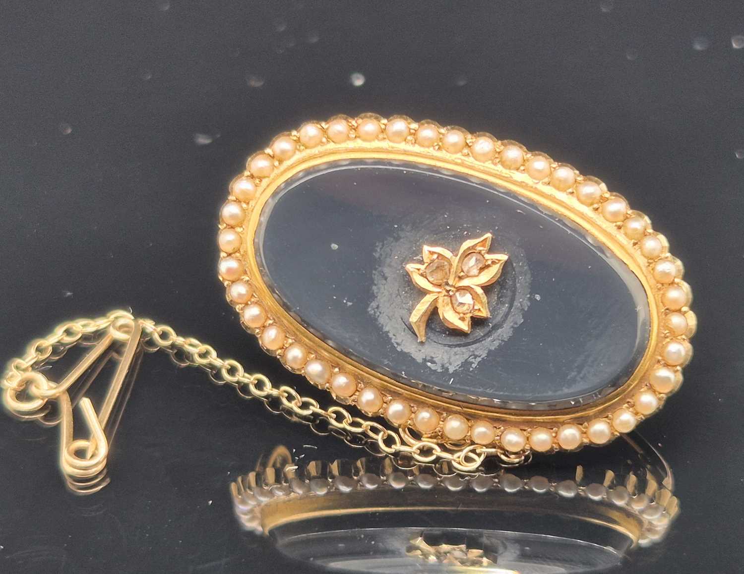 Lot 76 - An antique seed pearl, diamond and black...