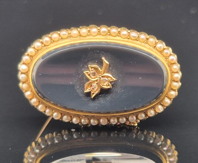 Lot 76 - An antique seed pearl, diamond and black...