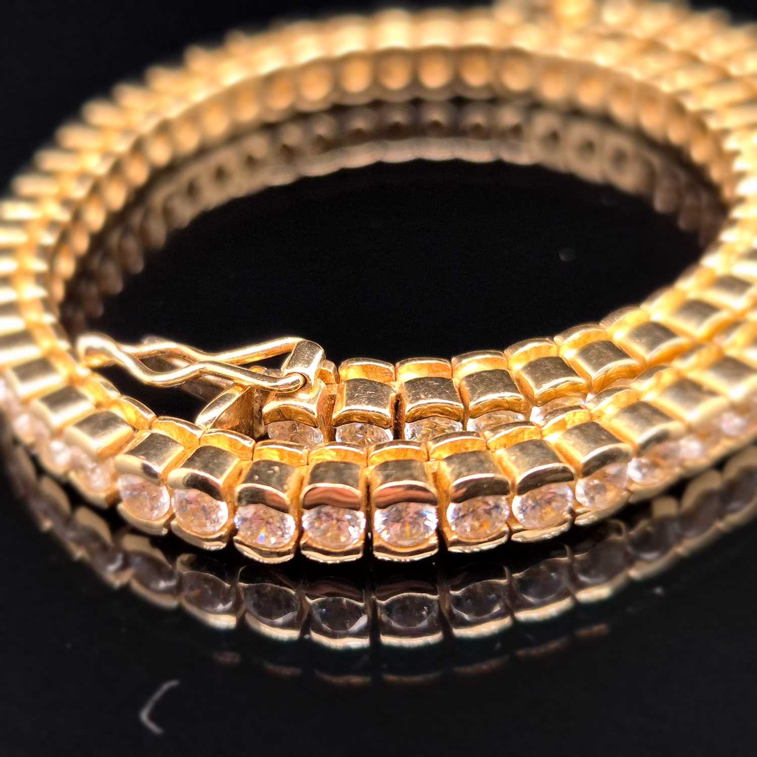 Lot 95 - A cz set tennis bracelet. Length 18.5 cm....