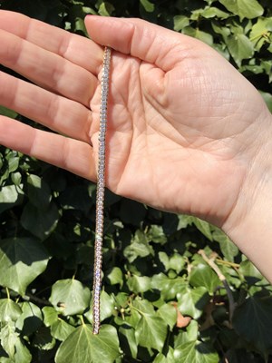 Lot 95 - A cz set tennis bracelet. Length 18.5 cm....