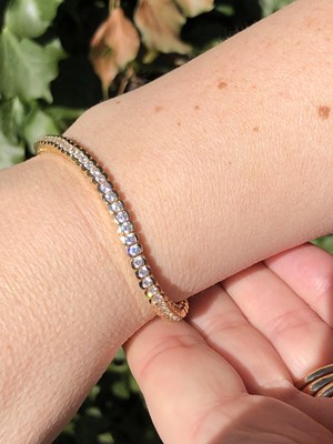 Lot 95 - A cz set tennis bracelet. Length 18.5 cm....