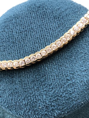 Lot 95 - A cz set tennis bracelet. Length 18.5 cm....