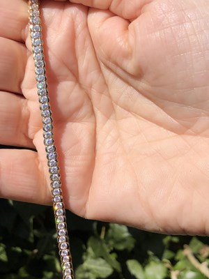 Lot 95 - A cz set tennis bracelet. Length 18.5 cm....