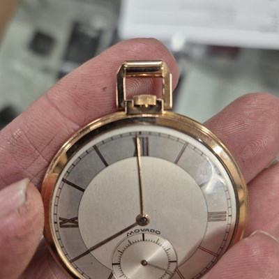 Lot 552 - A Movado 18ct gold slimline pocket watch with...
