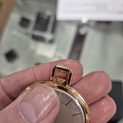 Lot 552 - A Movado 18ct gold slimline pocket watch with...