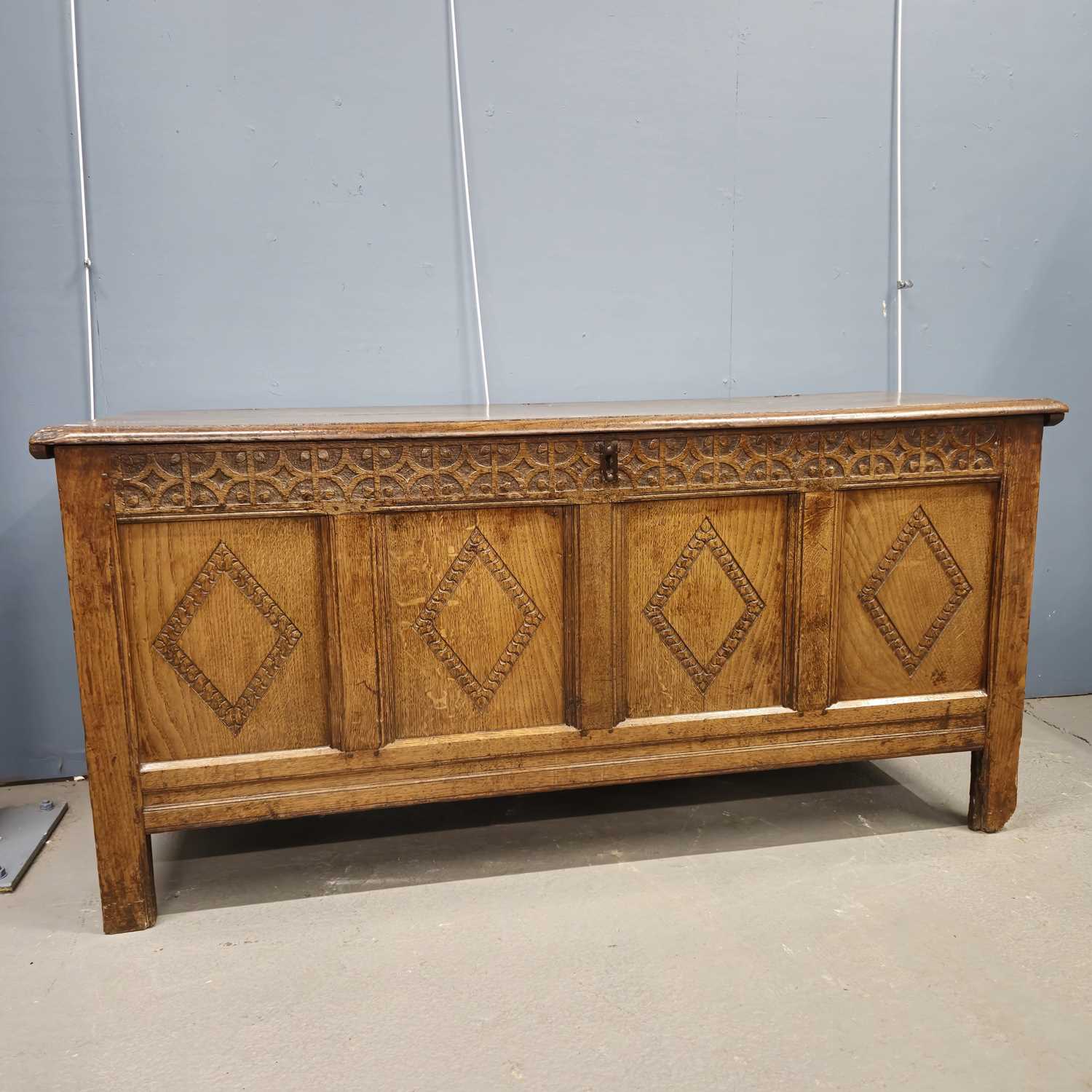 Lot 588 - An 18th century oak coffer with the four front...