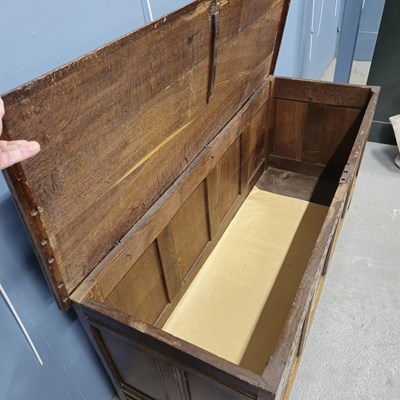 Lot 588 - An 18th century oak coffer with the four front...