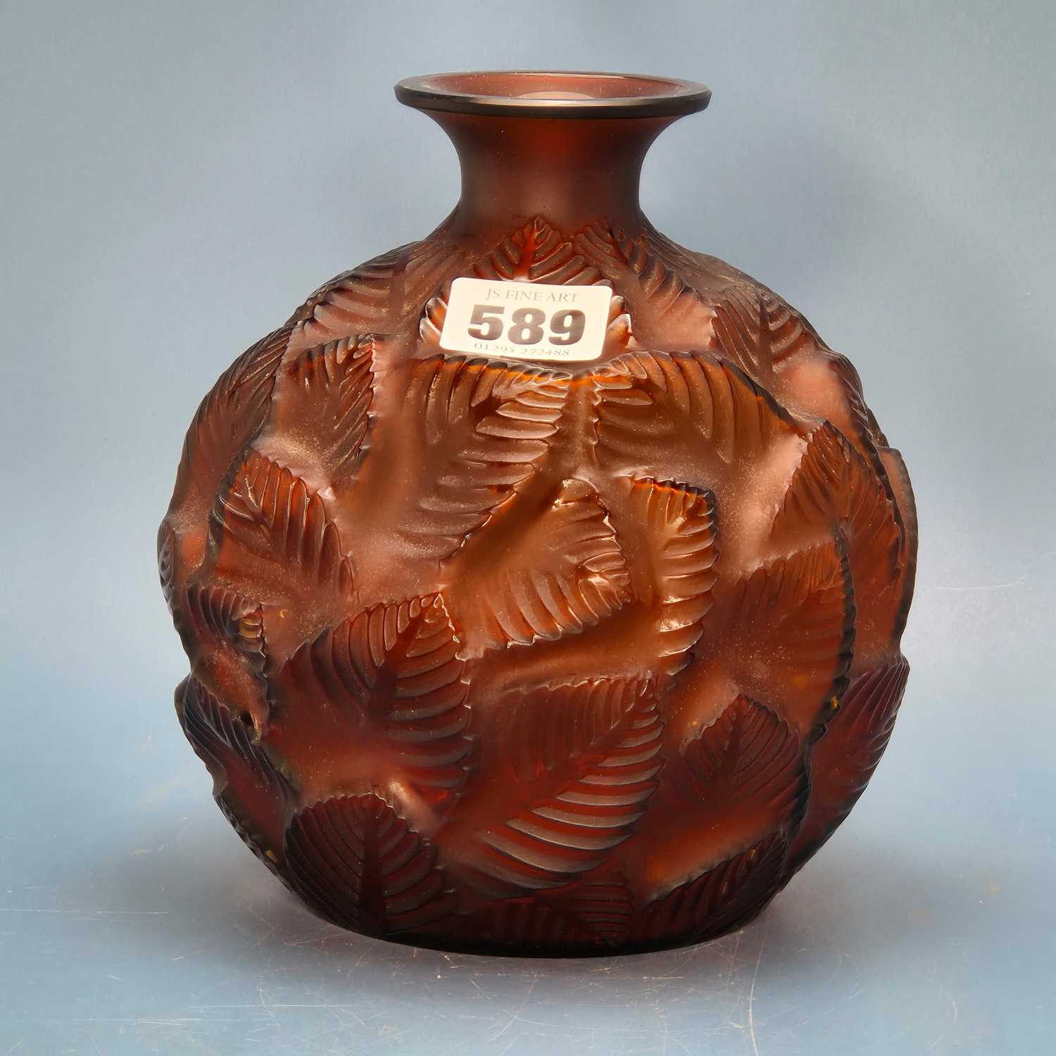 Lot 589 - A Lalique Feuilles Votive pattern amber glass...