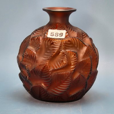 Lot 589 - A Lalique Feuilles Votive pattern amber glass...