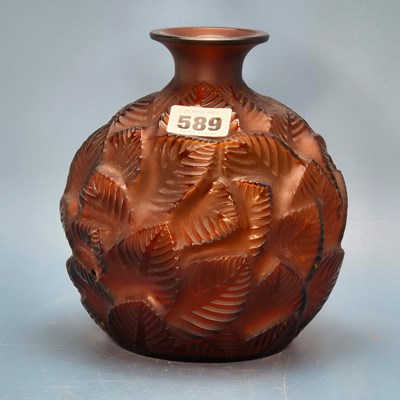 Lot 589 - A Lalique Feuilles Votive pattern amber glass...