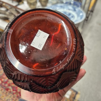 Lot 589 - A Lalique Feuilles Votive pattern amber glass...
