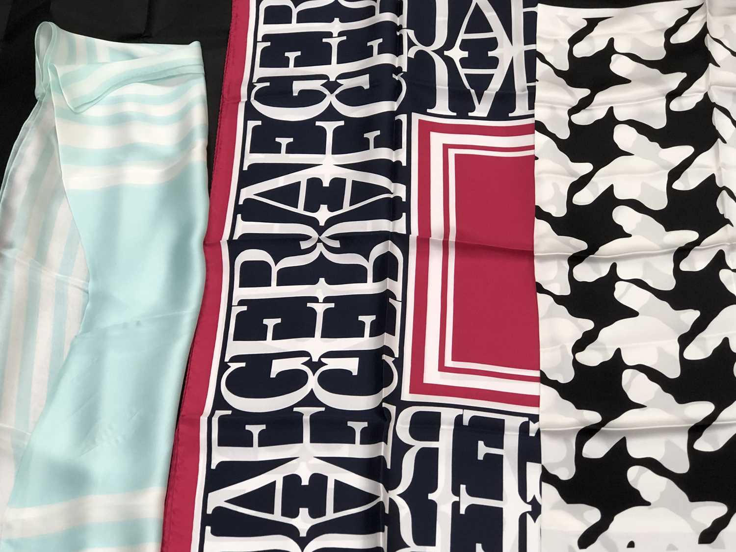 Lot 1130 - A pink and navy Jaeger logo silk scarf,...