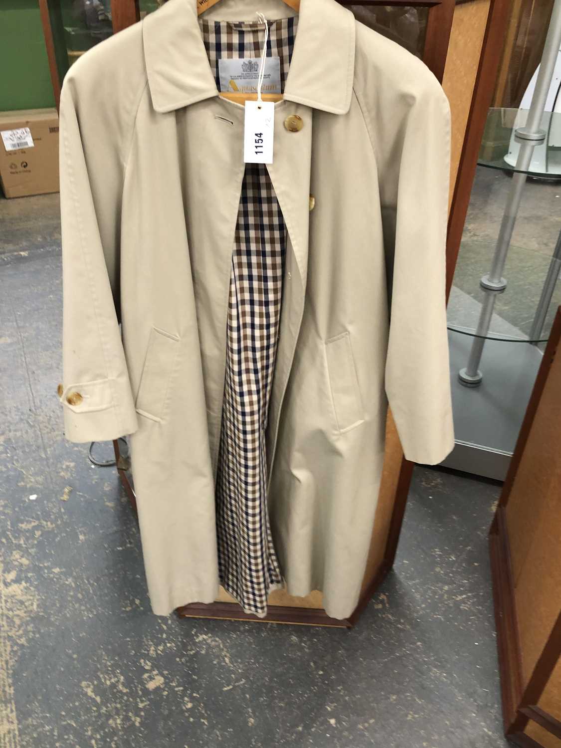 Lot 1154 - An Aquascutum trench coat together with a...