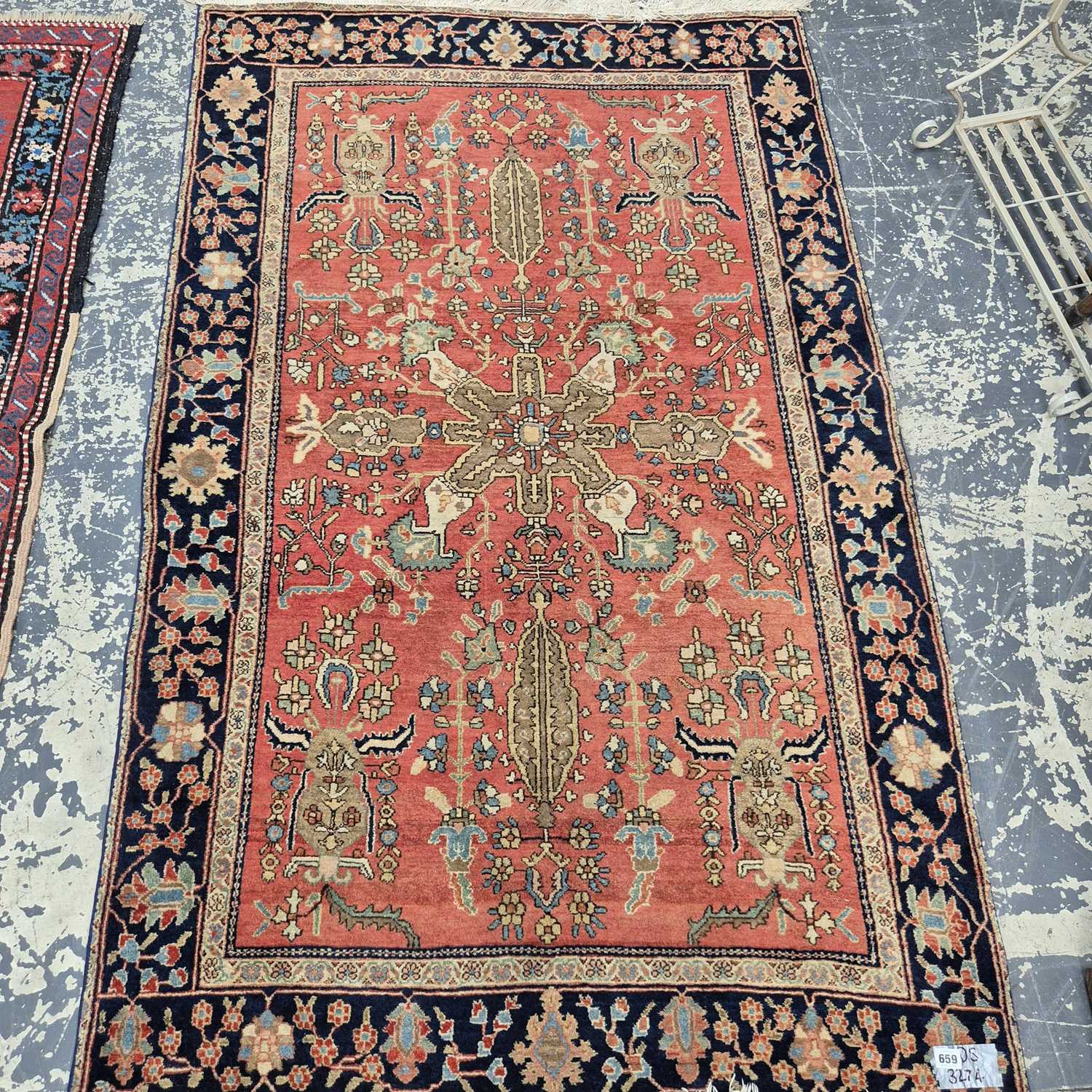 Lot 659 - An antique Persian sarouk rug. 118 x 192 cm